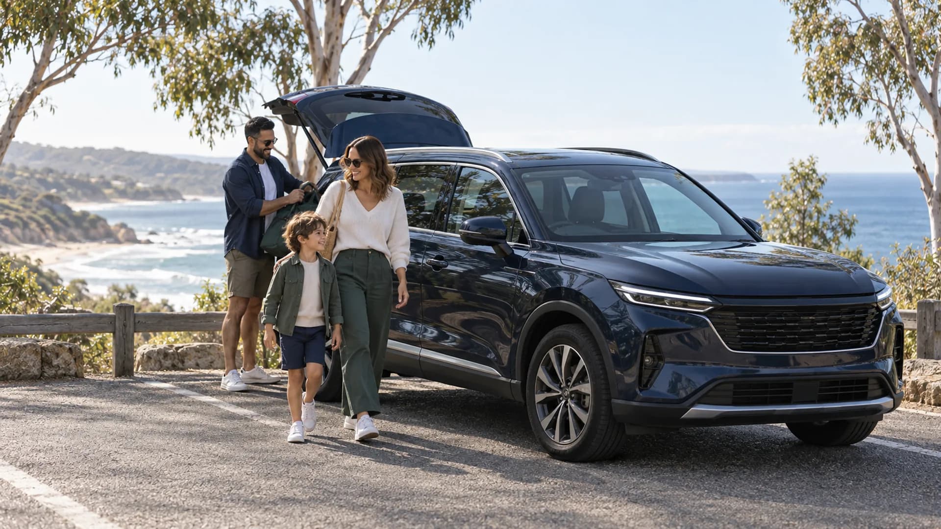 Family beside a navy SUV parked at an Australian coastal lookout